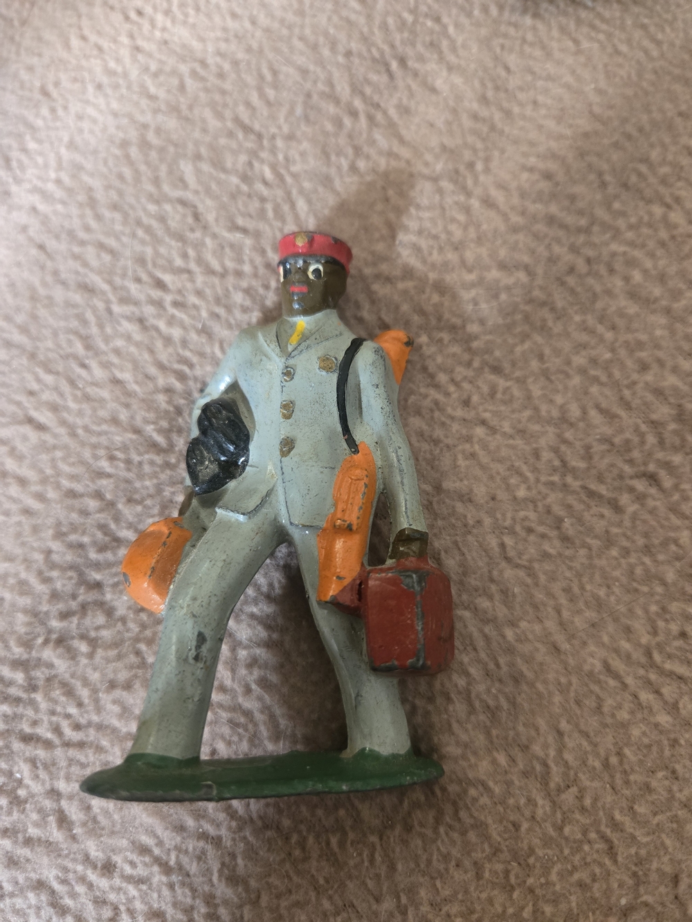 Antique gray and orange painted bellhop action figure